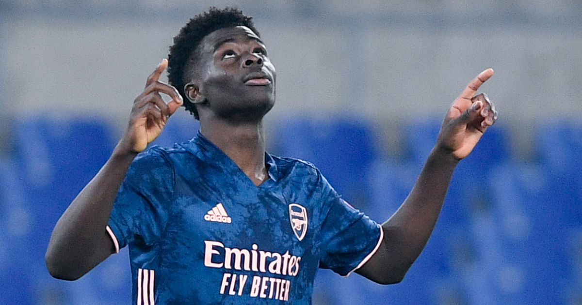 Bukayo Saka celebrates scoring a goal for Arsenal against Benfica.