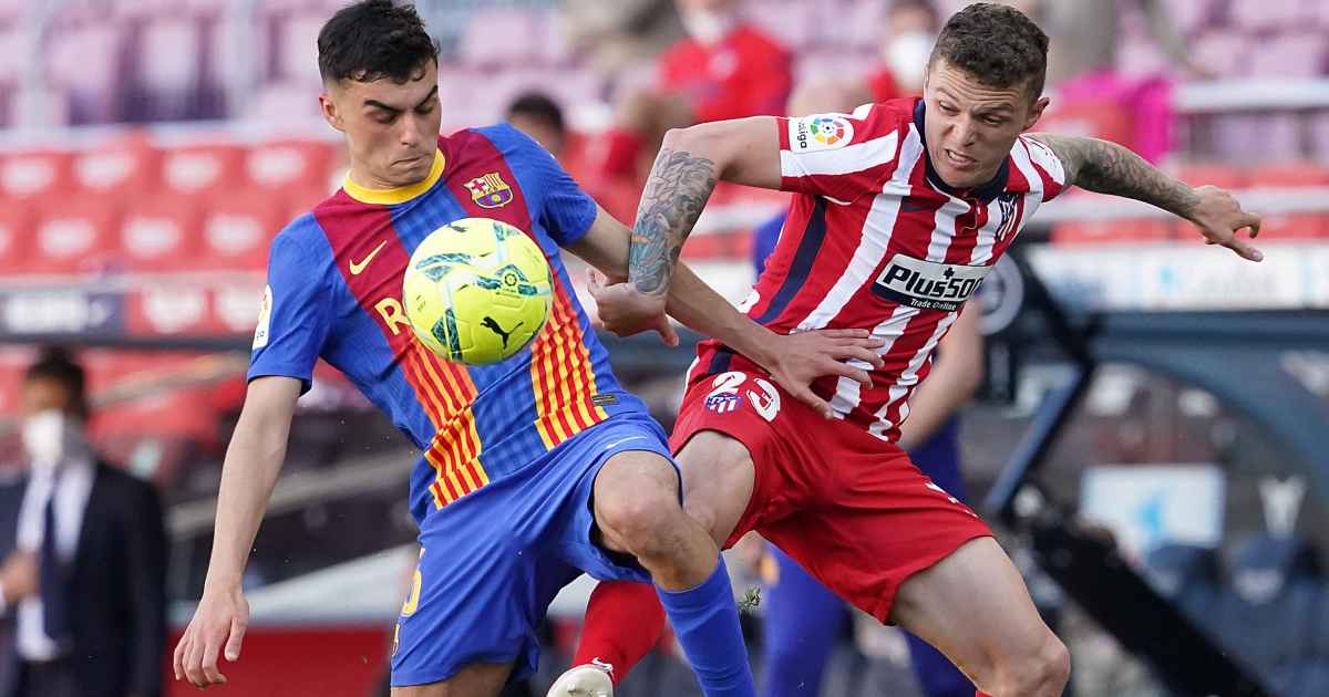 Pedri of Barcelona and Kieran Trippier of Atletico Madrid battle for the ball, May 2021